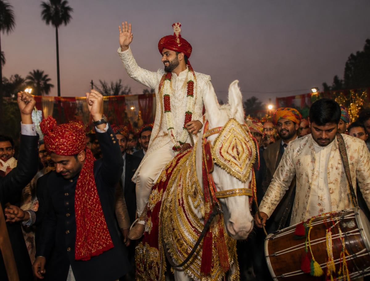 Rajasthani baraat procession with groom on a white horse